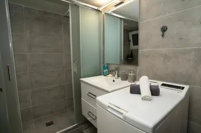 a bathroom with a sink and a mirror at Angel Apartment in Athens
