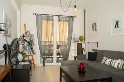 a living room with a couch and a table at Angel Apartment in Athens