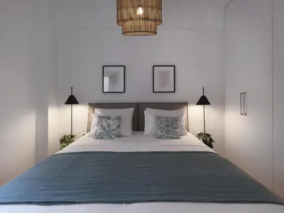a bedroom with a large white bed with pillows at Aiginitou6 in Athens