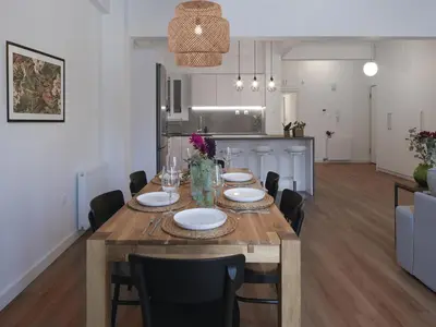 a dining room and kitchen with a table and chairs at Aiginitou6 in Athens