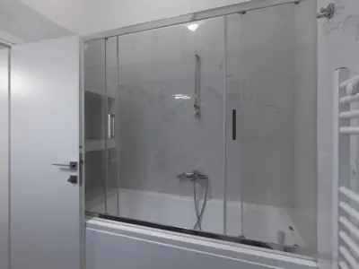 a shower with a glass door in a bathroom at Aiginitou6 in Athens
