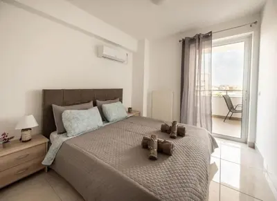 a bedroom with a bed with two teddy bears on it at Cozy 2-bedroom Apartment in Piraeus (ERM_E9) in Piraeus