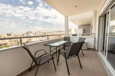 a balcony with a table and chairs and a view at Cozy 2-bedroom Apartment in Piraeus (ERM_E9) in Piraeus