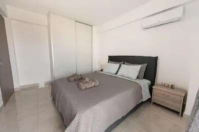 a bedroom with a bed with two stuffed animals on it at Cozy 2-bedroom Apartment in Piraeus (ERM_E9) in Piraeus