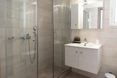a bathroom with a shower and a sink at Cozy 2-bedroom Apartment in Piraeus (ERM_E9) in Piraeus