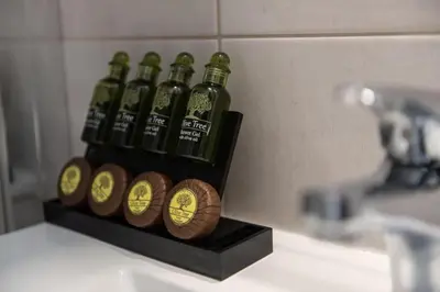 a group of four bottles of beer sitting on a sink at Cozy 2-bedroom Apartment in Piraeus (ERM_E9) in Piraeus