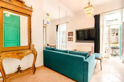a living room with a blue couch and a mirror at Neoclassical Loft in Monastiraki - Acropolis and metro in Athens