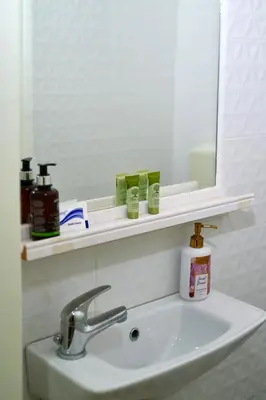 a bathroom with a sink and a mirror and a sink at Marina's Luxurious Apartment in Athens, Centre in Athens