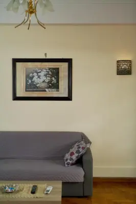 a living room with a couch and a picture on the wall at Marina's Luxurious Apartment in Athens, Centre in Athens