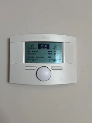 a microwave oven is hanging on a wall at Dafni City Apartment 3 in Athens