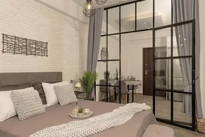 a living room with a bed and a dining room at Our Cosy home - AT001 in Athens