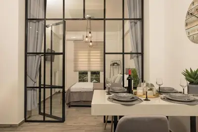a dining room with a table and a mirror at Our Cosy home - AT001 in Athens