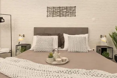 a bed with white pillows and a tray of food on it at Our Cosy home - AT001 in Athens