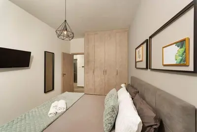 a living room with a bed and a couch at Our Cosy home - AT001 in Athens