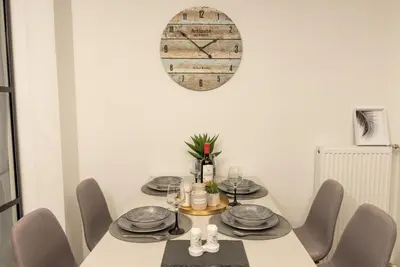a dining room with a table with chairs and a mirror at Our Cosy home - AT001 in Athens