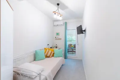 a living room with a couch and a window at Aiolos kolonaki near Hilton super lux apartment in Athens