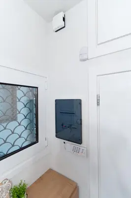 a flat screen tv hanging on a white wall at Aiolos kolonaki near Hilton super lux apartment in Athens