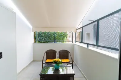 a balcony with two chairs and a table at Aiolos kolonaki near Hilton super lux apartment in Athens