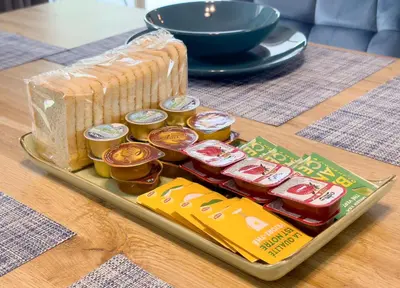 a tray with food and a sandwich and chips on a table at Metamorfoseos Spacious 120sqm apt in Alimos in Athens