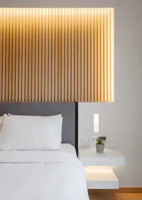 a bedroom with a white bed and a yellow wall at Kreoli Hotel in Athens