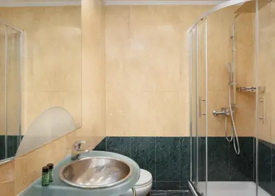 a bathroom with a sink and a toilet and a shower at Kreoli Hotel in Athens