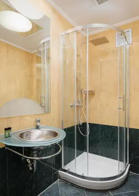 a bathroom with a sink and a shower at Kreoli Hotel in Athens
