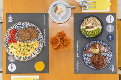 a table with two plates of food on it at Acropol Hotel in Athens