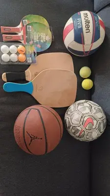 a group of balls and other items on the floor at quiet apartment with a large balcony near the sea in Athens