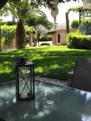 a black lantern sitting on top of a table at NATURE & SEA in Saronida