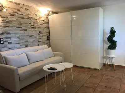 a living room with a couch and a table at NATURE & SEA in Saronida