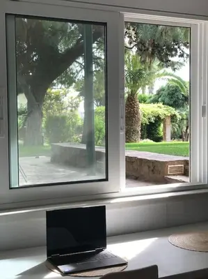 a laptop sitting on a desk in front of a window at NATURE & SEA in Saronida