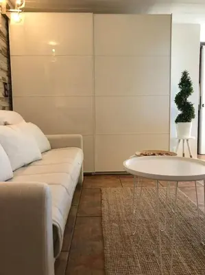 a living room with a couch and a table at NATURE & SEA in Saronida