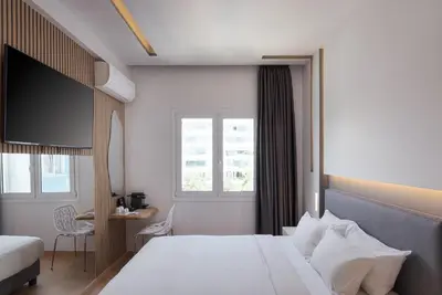a hotel room with a bed and a window at Mirada Hotel in Athens