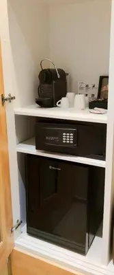 a microwave sitting on a shelf in a kitchen at Mirada Hotel in Athens