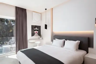 a bedroom with a large bed and a window at Mirada Hotel in Athens
