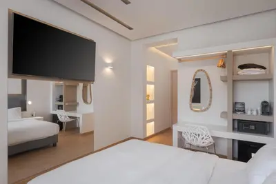 a bedroom with a bed and a flat screen tv at Mirada Hotel in Athens
