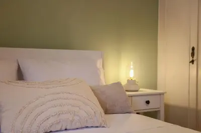 a bedroom with a bed with a lamp on a table at Πολυτελές διαμέρισμα-Πασαλιμάνι in Piraeus