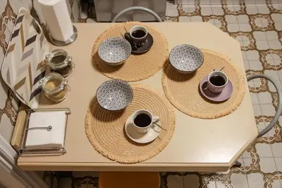 a table with hats and cups of coffee on it at Πολυτελές διαμέρισμα-Πασαλιμάνι in Piraeus