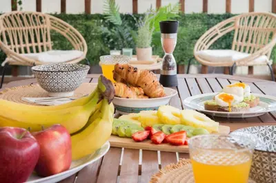 a table with plates of food and fruit on it at Πολυτελές διαμέρισμα-Πασαλιμάνι in Piraeus
