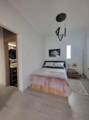 a bedroom with a bed in a white room at Under the Hill in Athens