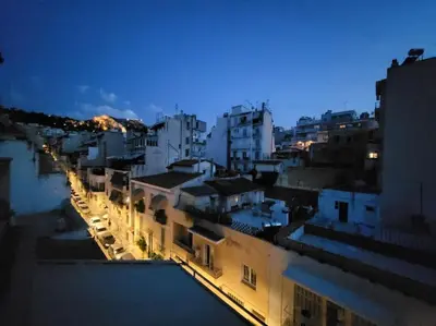 a view of a city at night with buildings at Under the Hill in Athens