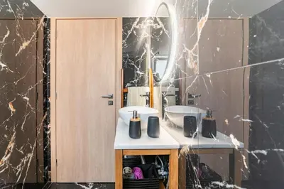 a bathroom with a sink and a mirror at Under the Hill in Athens