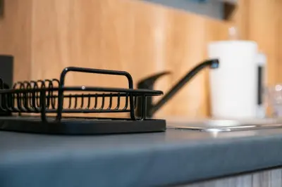 a black counter top with a holder on it at Lux Modern Apt Ανακαινισμένο διαμέρισμα 150m από την πλαζ 'ΈΔΕΜ' in Athens
