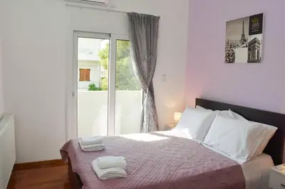 a bedroom with a bed with two towels on it at Cozy Cloud Apartment in Markopoulo