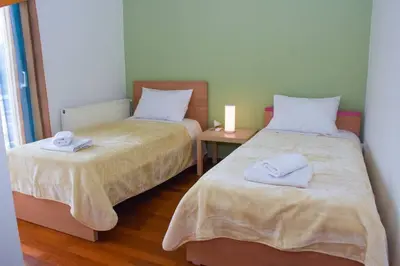 a bedroom with two beds with towels on them at Cozy Cloud Apartment in Markopoulo
