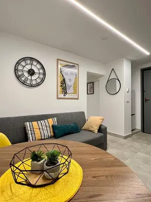a living room with a couch and a table at Attiki Apartment VIPGreece in Athens