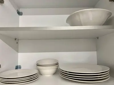 two stacks of plates on a shelf in a kitchen at Attiki Apartment VIPGreece in Athens