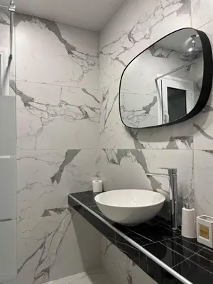 a bathroom with a sink and a mirror at Attiki Apartment VIPGreece in Athens