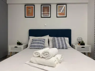 a bedroom with a bed with towels on it at Attiki Apartment VIPGreece in Athens