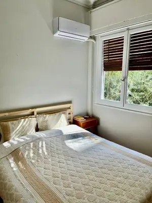 a bedroom with a large bed and a window at Athens Classic Luxury 2-Bedroom Apartment in Athens